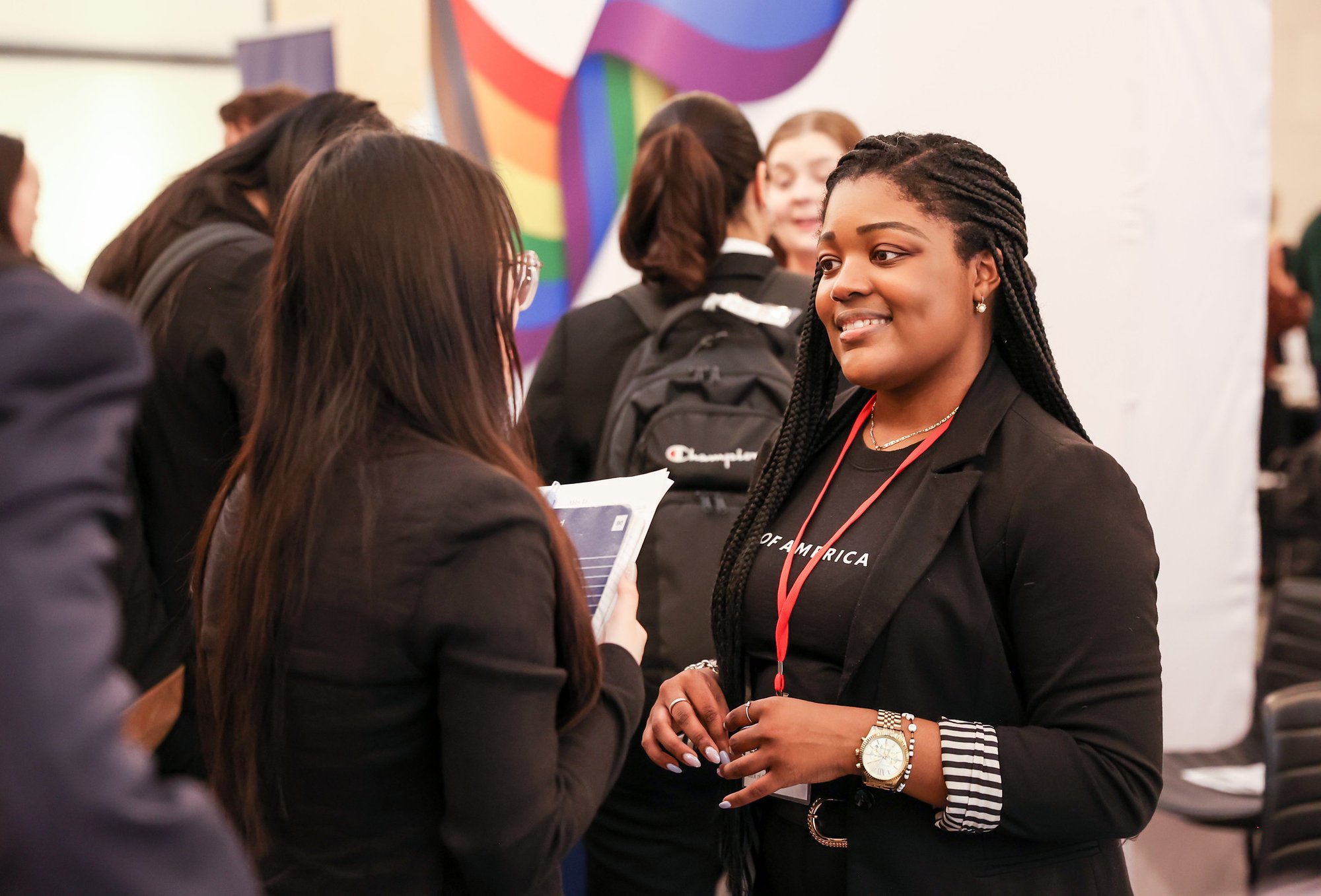 Two individuals talking at a career fair.